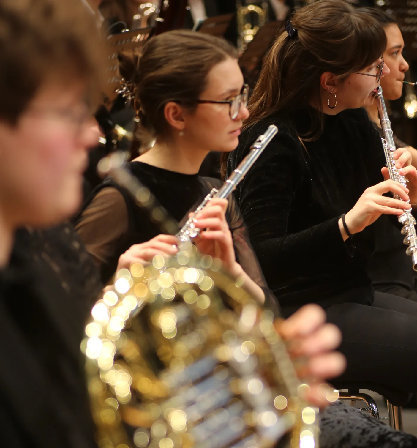 Agatha playing flute in an ensemble